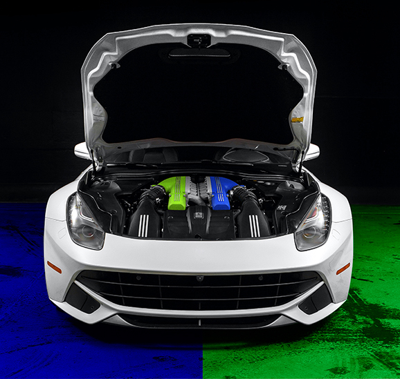 white sports car with green and blue colored engine 